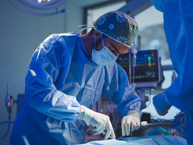Surgery in the operating room performing a surgical procedure on a patient