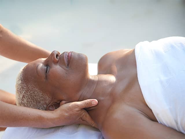 A female oncology patient is getting a massage