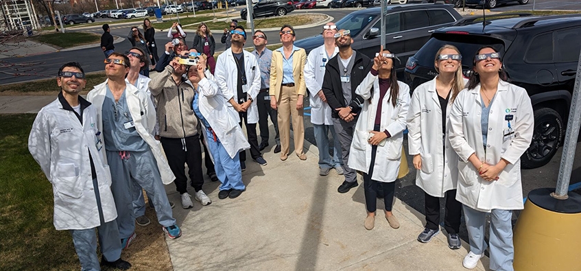 ophthalmology residents watching eclipse with protective glasses