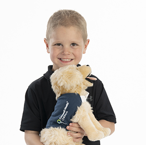 Boy holding dog stuffed animal