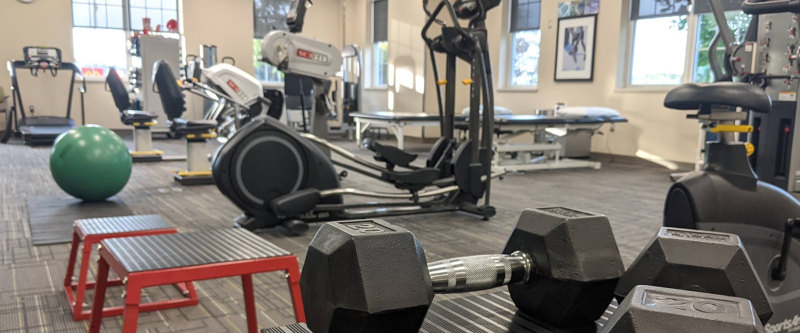 A well-equipped gym space showcasing exercise equipment and a bench for fitness routines and training sessions.