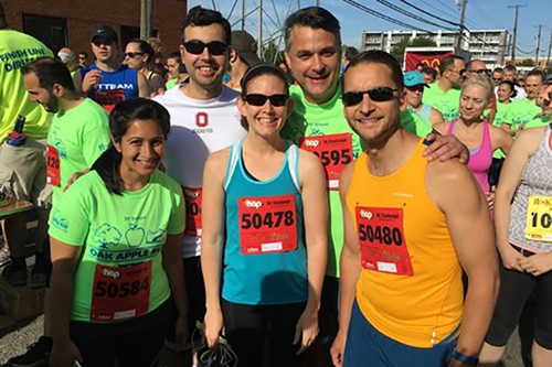 A cheerful group of people gathered for a photo at a race, showcasing their commitment to health and fitness.