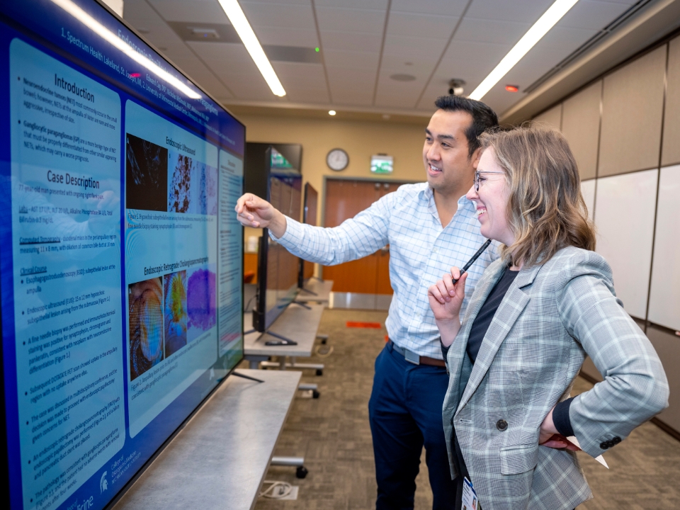 two employees of the research institute reviewing something on a monitor