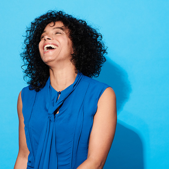 Laughing woman with curly black hair