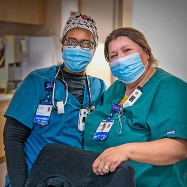 Two medical providers wearing masks.