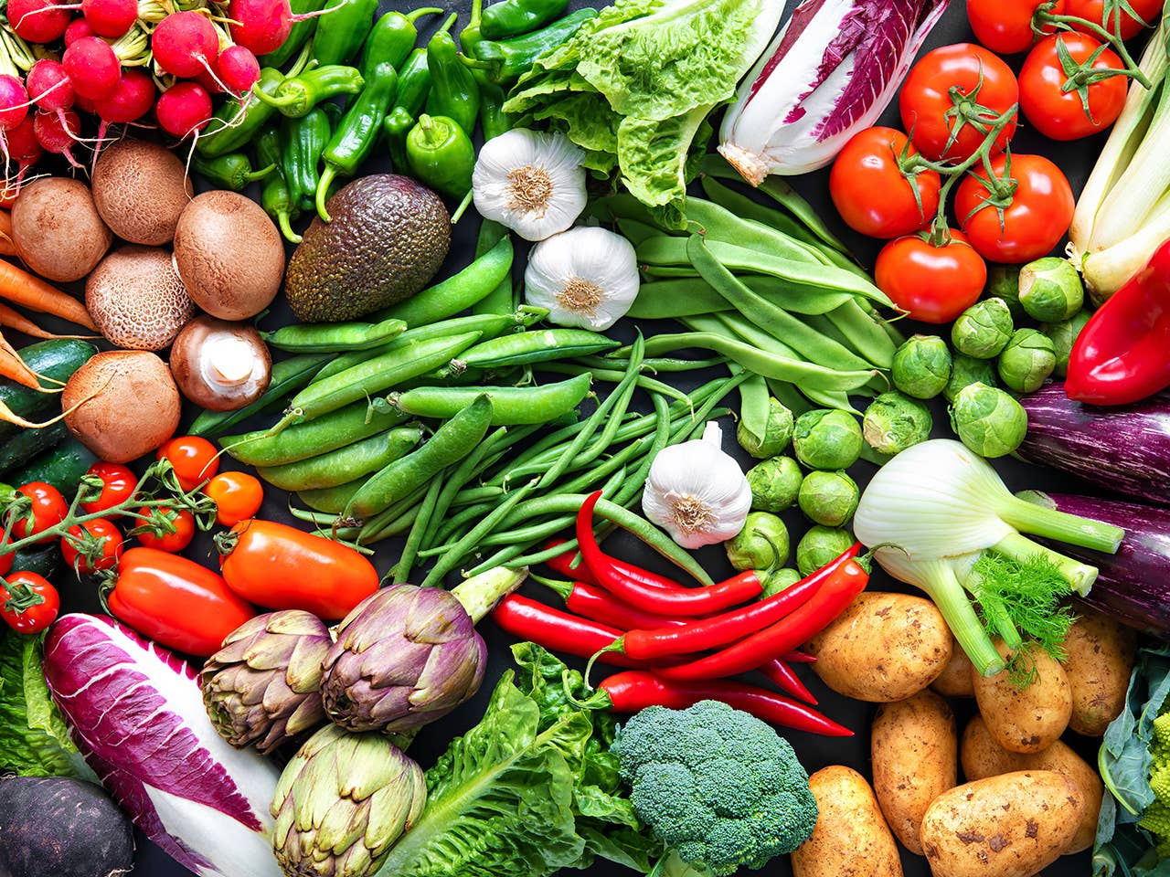 A vibrant display of various fruits and vegetables arranged together in a colorful assortment.