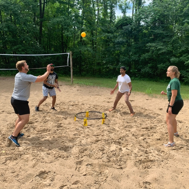 people outside playing volleyball