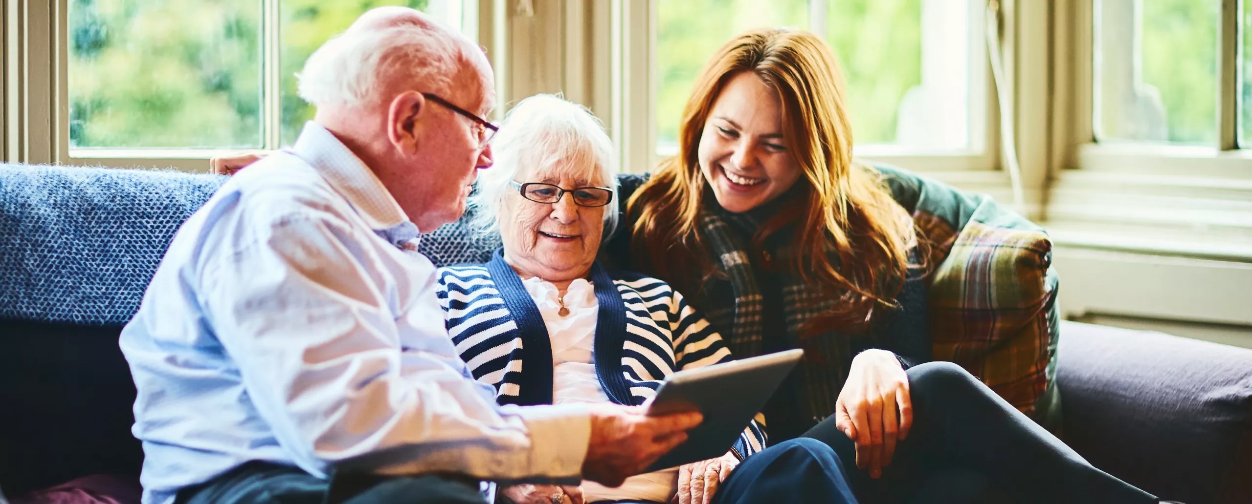 Three people smiling at a picture