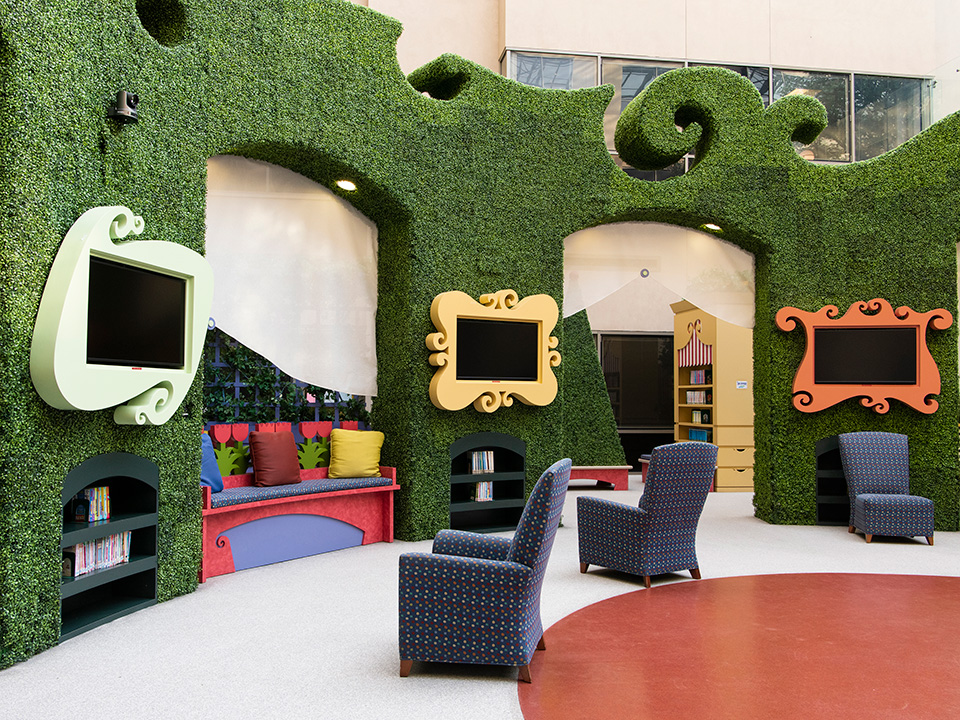 Children's Miracle Network Garden at Corewell Health William Beaumont University Hospital, a brightly lit room with multiple televisions and sofa chairs