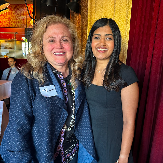 Two attendees posing together for a photo at a residency celebration dinner