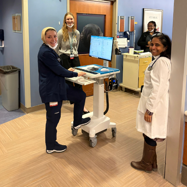 Staff and fellows having a conversation in the hallway at the hospital