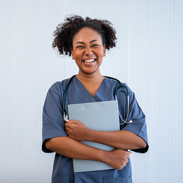 Health care professional standing and holding patient chart