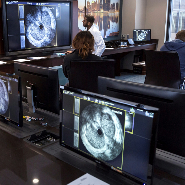 Residents looking at an image on the screen while a professor is teaching them
