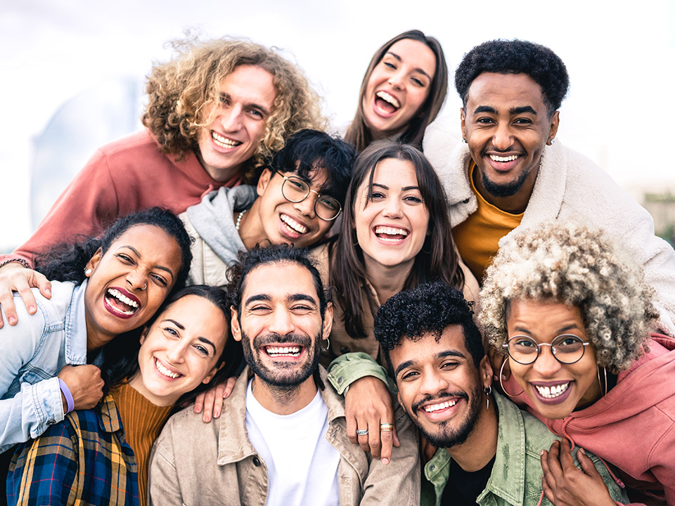 A diverse group of people smiling together, showcasing joy and camaraderie in a friendly gathering.