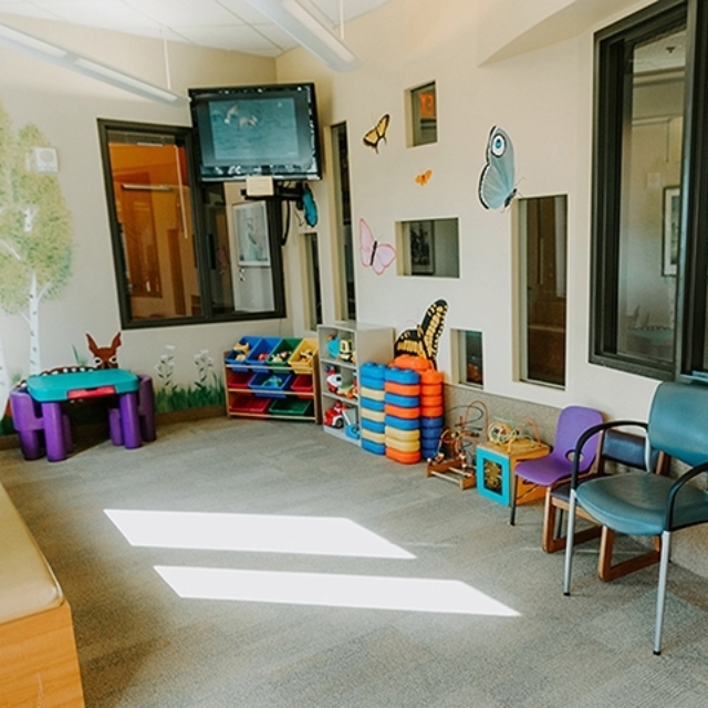 Waiting room with colorful artwork and toys in the pediatric urology clinic