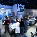 Several residents interacting in a hospital room, showcasing teamwork and collaboration in a healthcare setting.
