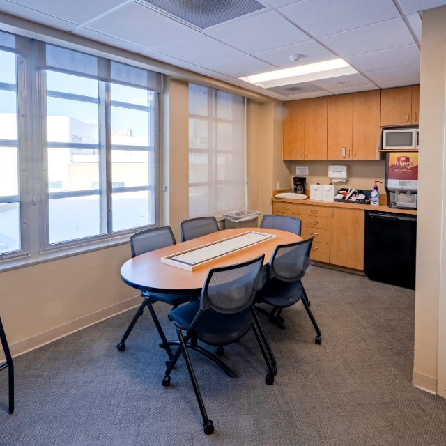 table and kitchen in the lunch area of the resident lounge