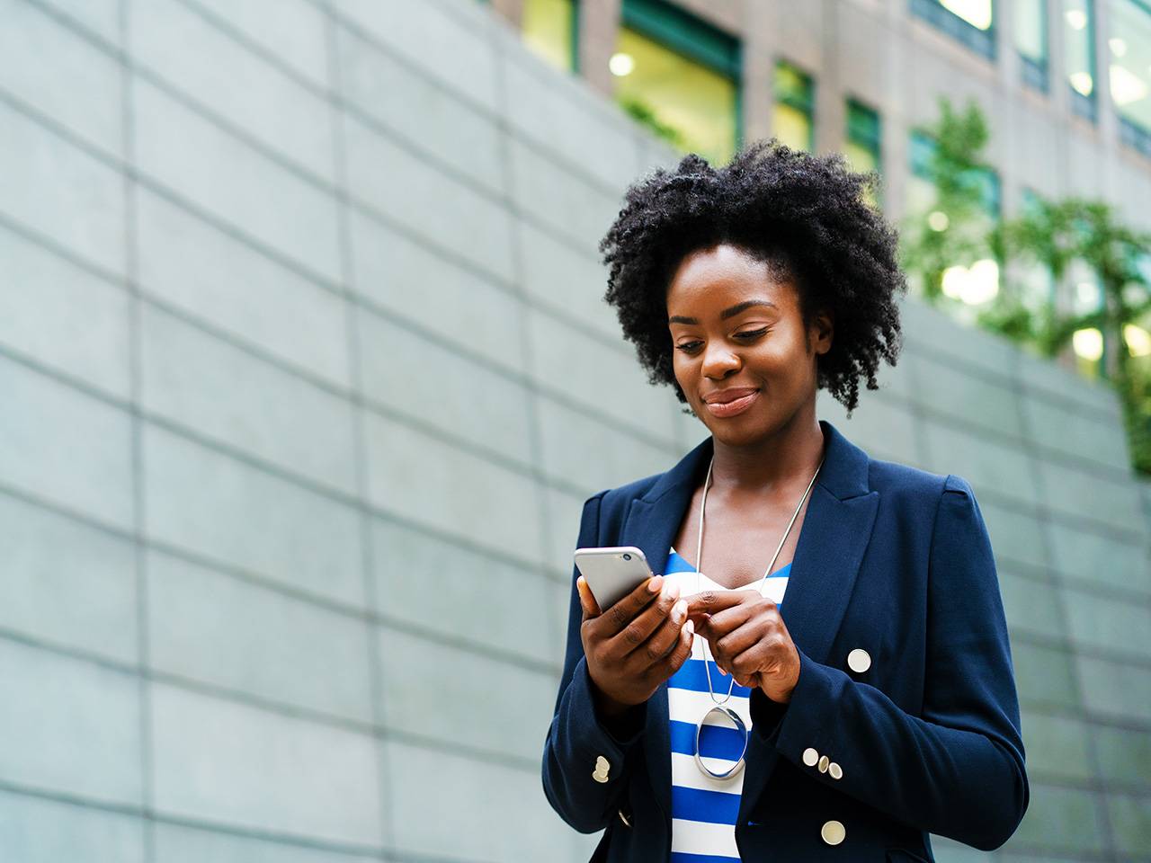Person using a smartphone outdoors to access health information, manage appointments, or view medical records online.