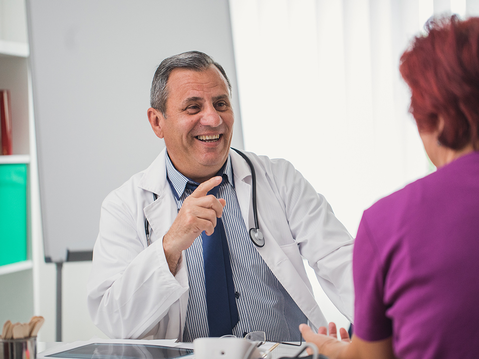 A physician engaged in conversation with a patient about their medical condition.