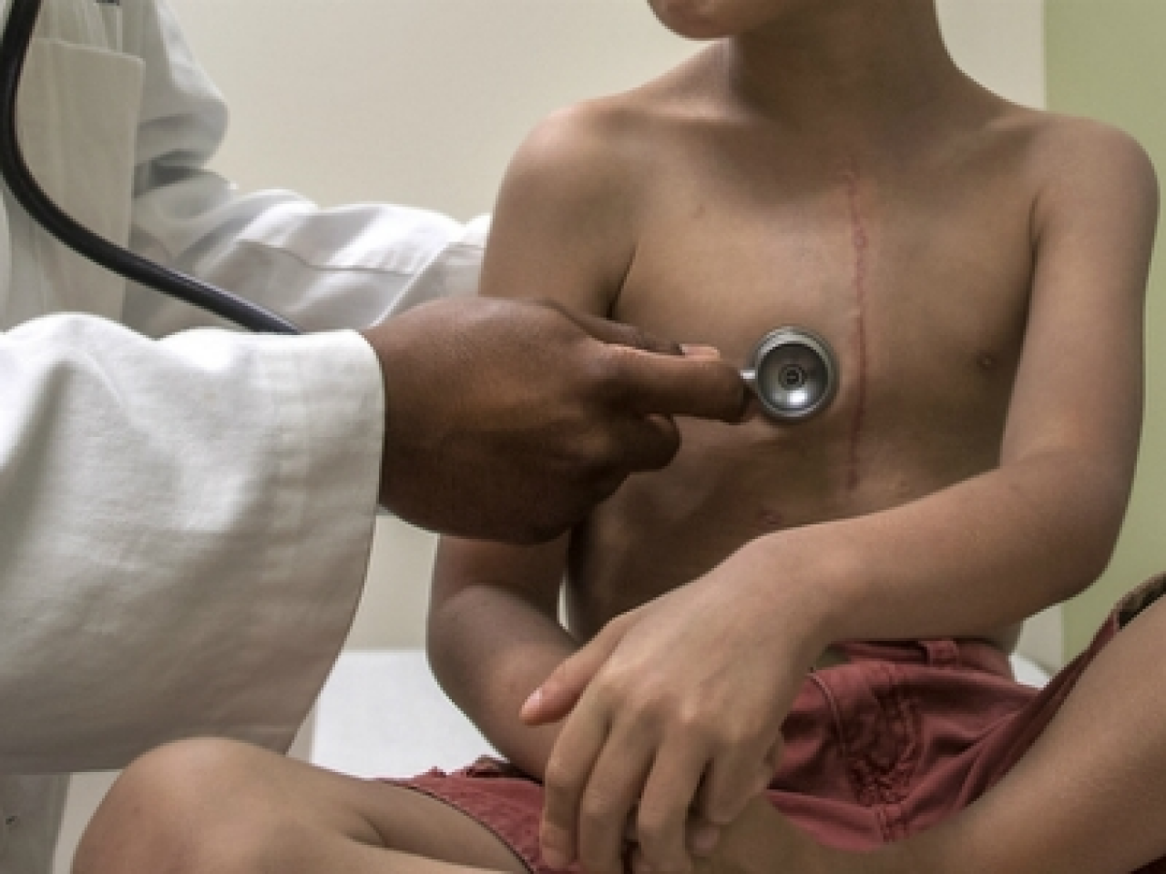 Doctor listening to a young patient's breathing