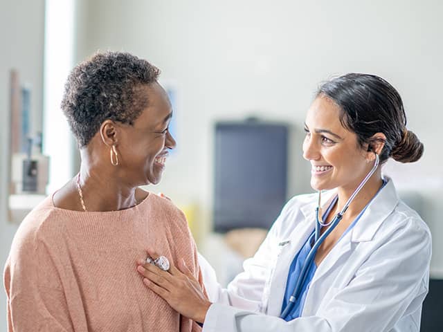 Doctor talking to a patient while they check out there heart
