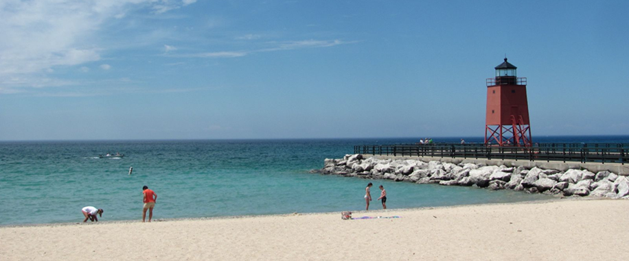 people at lake beach with break wall