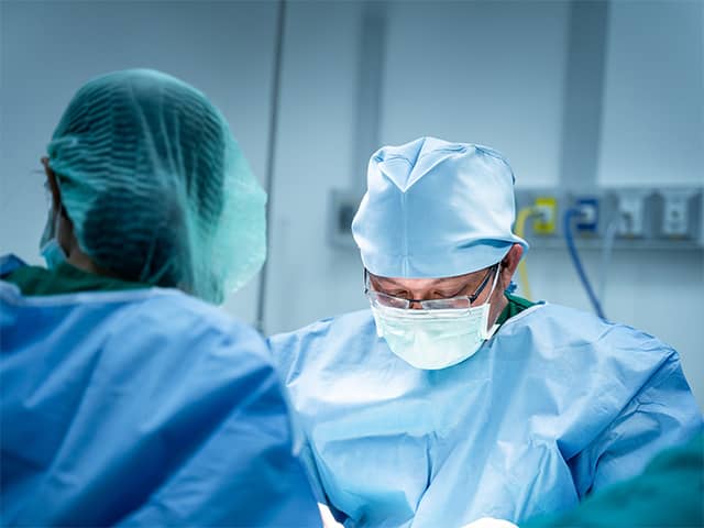 Surgeons in the operating room doing a spine surgery 