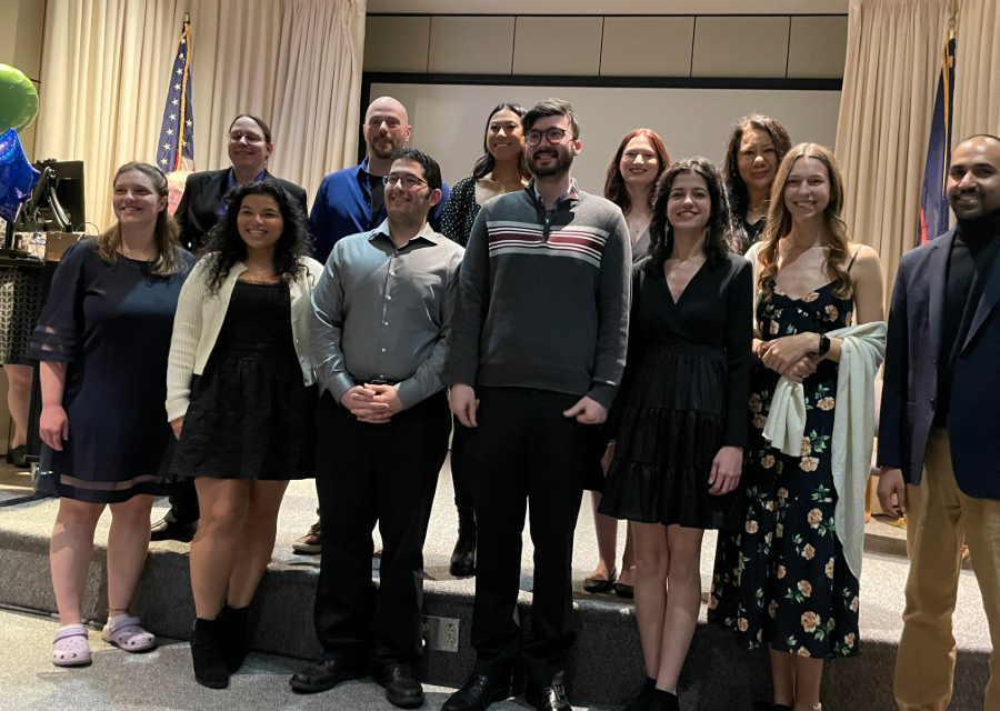 Group of program graduates posing for a group picture