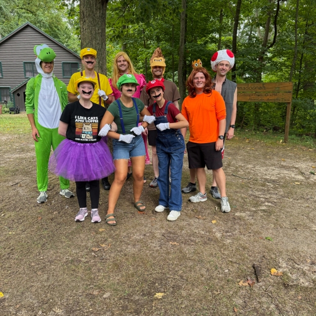 Residents in costumes posing for a group picture during the wilderness retreat