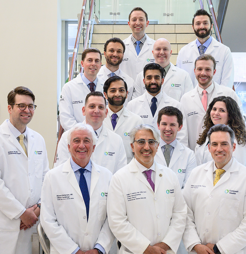 Team of doctors in white coats smiling for a photo at Corewell Health's Cardiovascular Disease Fellowship program.