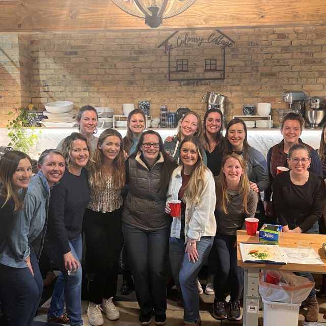 group of female residents posing for a picture at a group cooking class