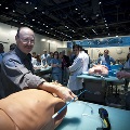 A man is focused on working with a dummy in a well-lit room, showcasing his skills and dedication to his craft.