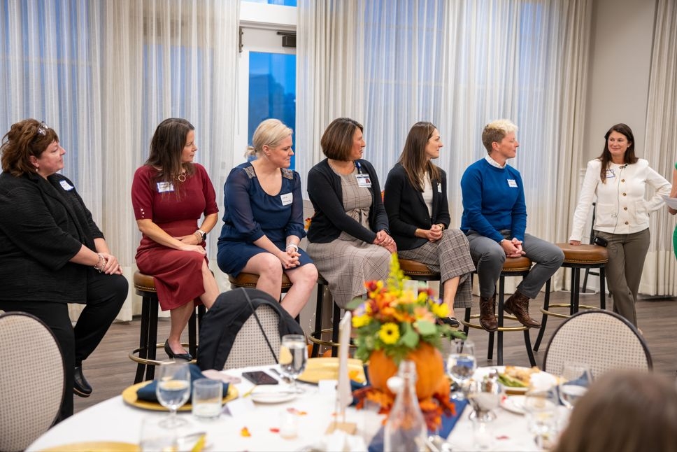 Panel members listening to someone speak during event