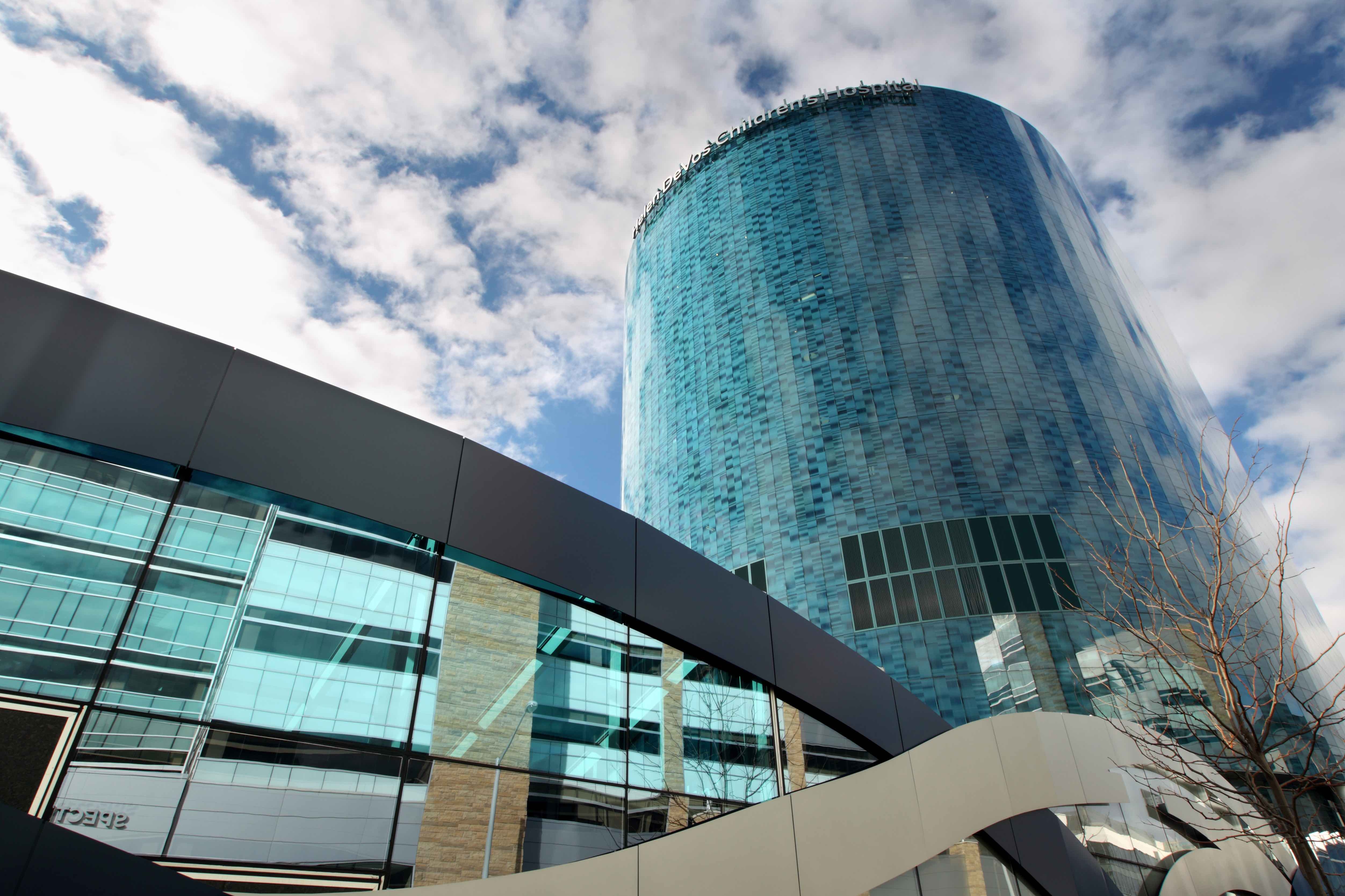 Helen DeVos Children’s Hospital with a blue sky and clouds