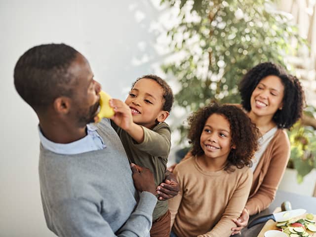Family sharing fresh fruit and healthy foods at home, building nutritious eating habits together
