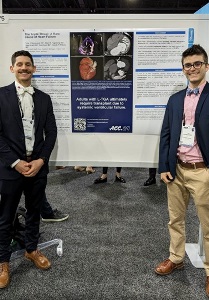 Two men stand beside a poster at the 2024 ACC conference, presenting a unique case of L-TGA.