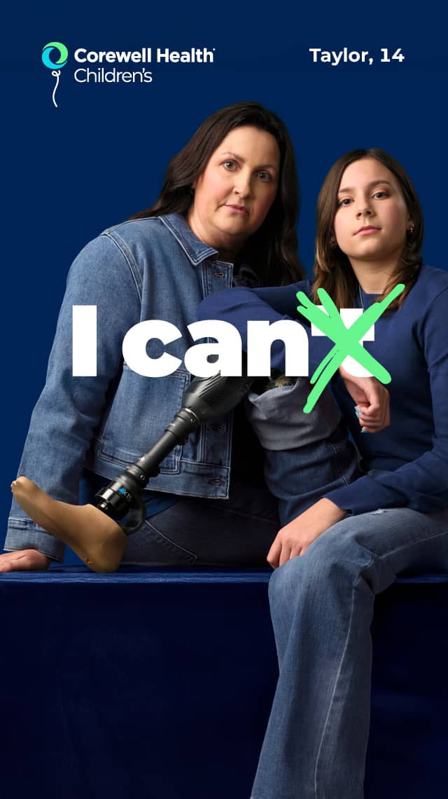 Taylor, a 14 year old patient, sits on a blue box with her prosthetic leg propped up, with her mom standing beside her