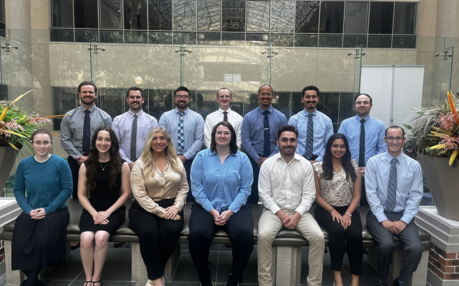 A diverse group of medical students stands on a rooftop, celebrating their acceptance into the Class of 2027.