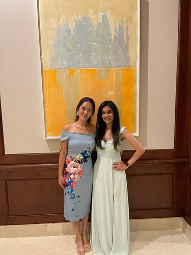 Two women dressed in formal attire stand together, embodying grace and professionalism in their appearance.