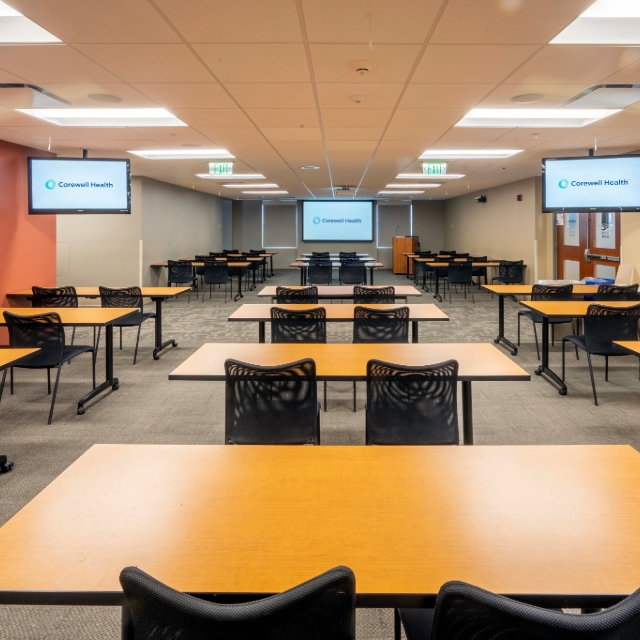 lecture hall with tables and large screen 