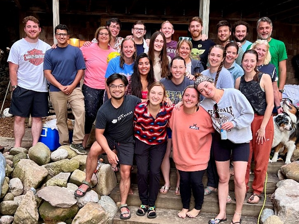  A group of residents enjoying a retreat on a porch, accompanied by a dog, fostering camaraderie and relaxation.