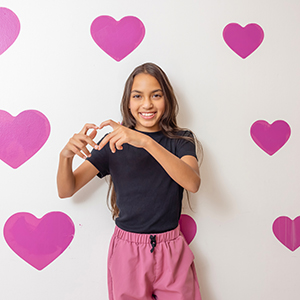 Girl making a heart sign with her hands