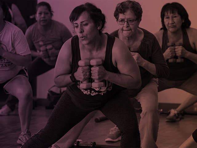 Group of women holding weights during a workout class.