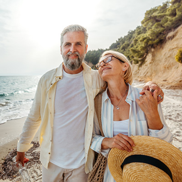 male and female couple standing on beach