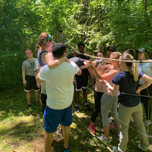 Residents participating in a group outdoor training activity with other residents