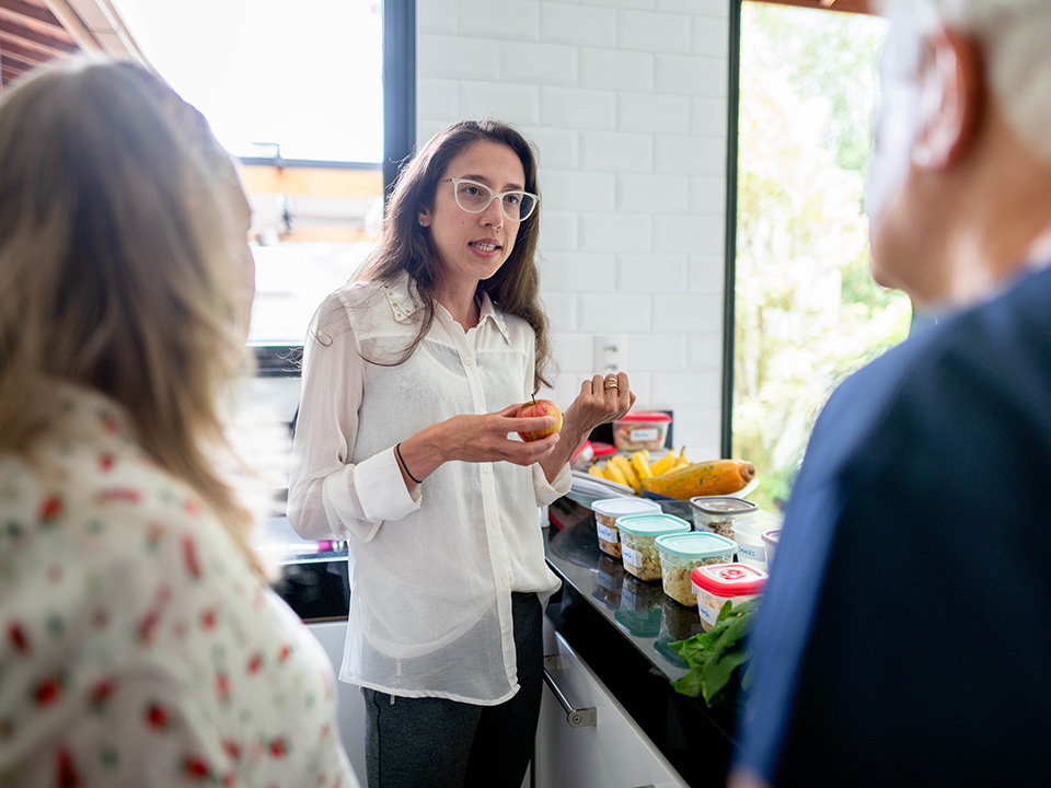 Lifestyle medicine culinary expert speaks with patients in a kitchen setting