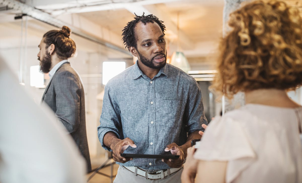 Homem negro em uma aula de conversação para se preparar para o exame Telc a2 de alemão.
