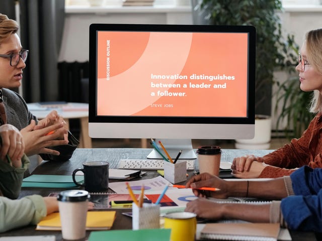 Funcionários em uma reunião conversando ideias com assertividade.