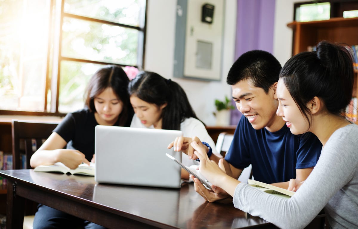 Jovens estudam em curso de tailandês online.
