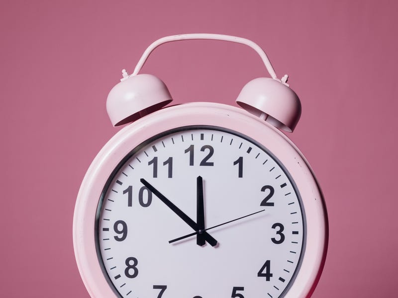 relógio de mesa rosa apontando as horas em inglês